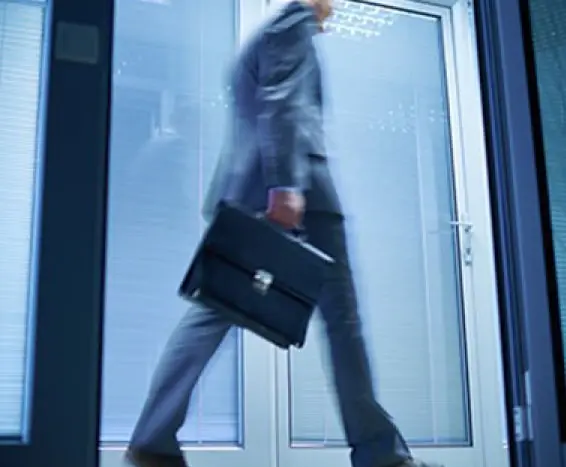 Business man walking out of the office with a briefcase